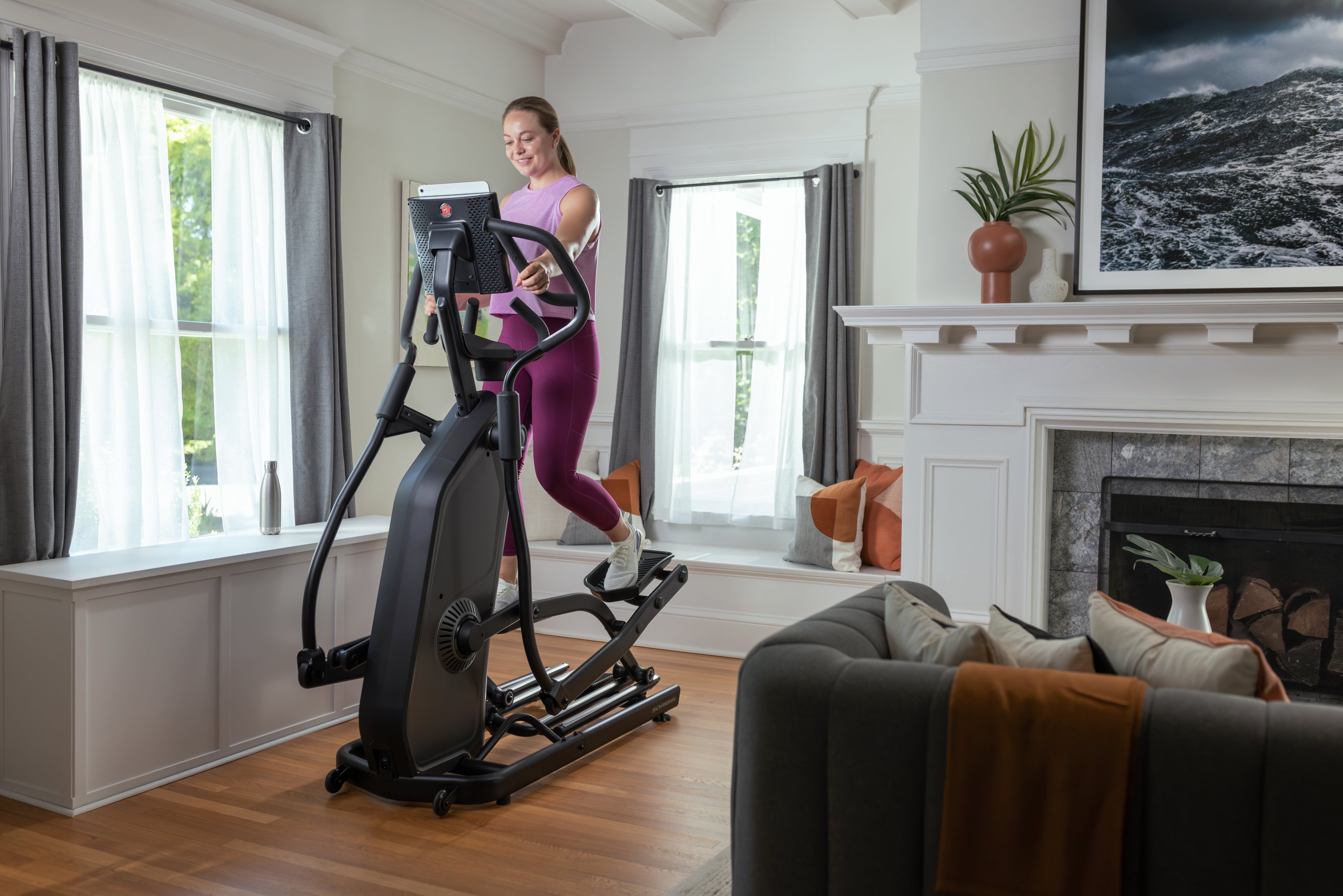 Woman using a Schwinn Elliptical in a home setting.