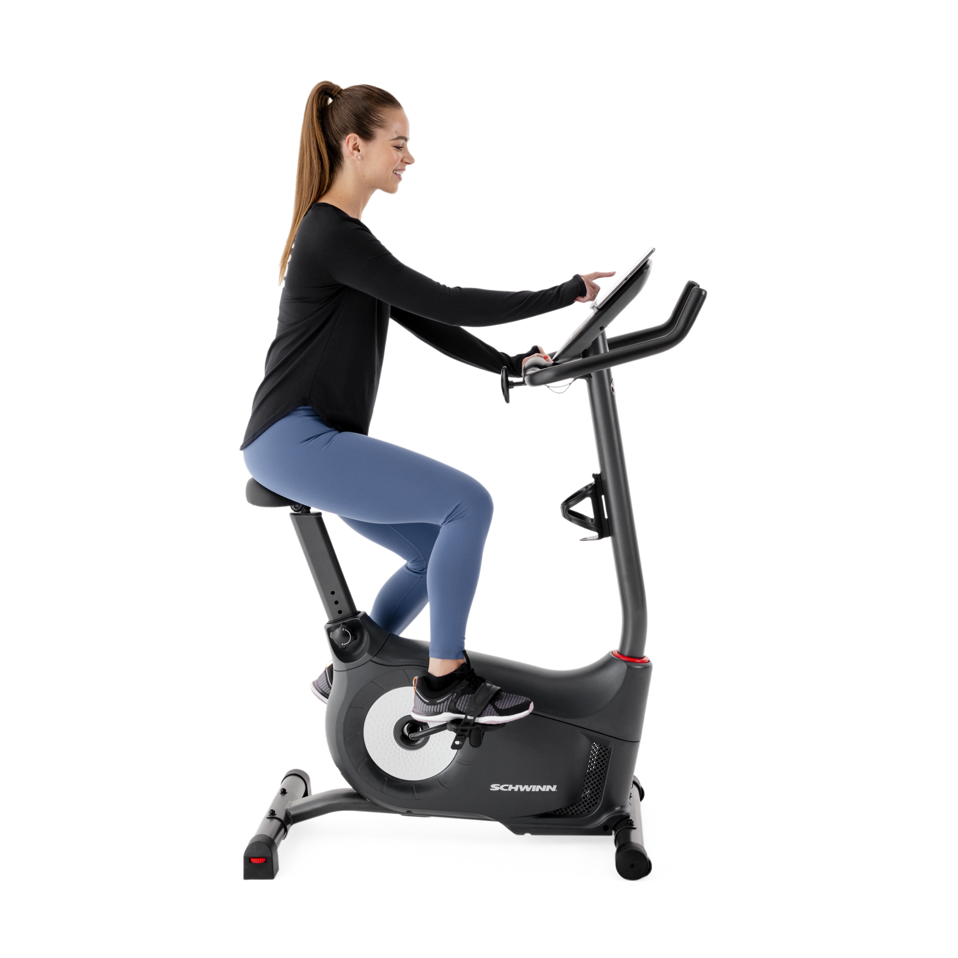Side view of a woman using the Schwinn 510U Upright Bike.