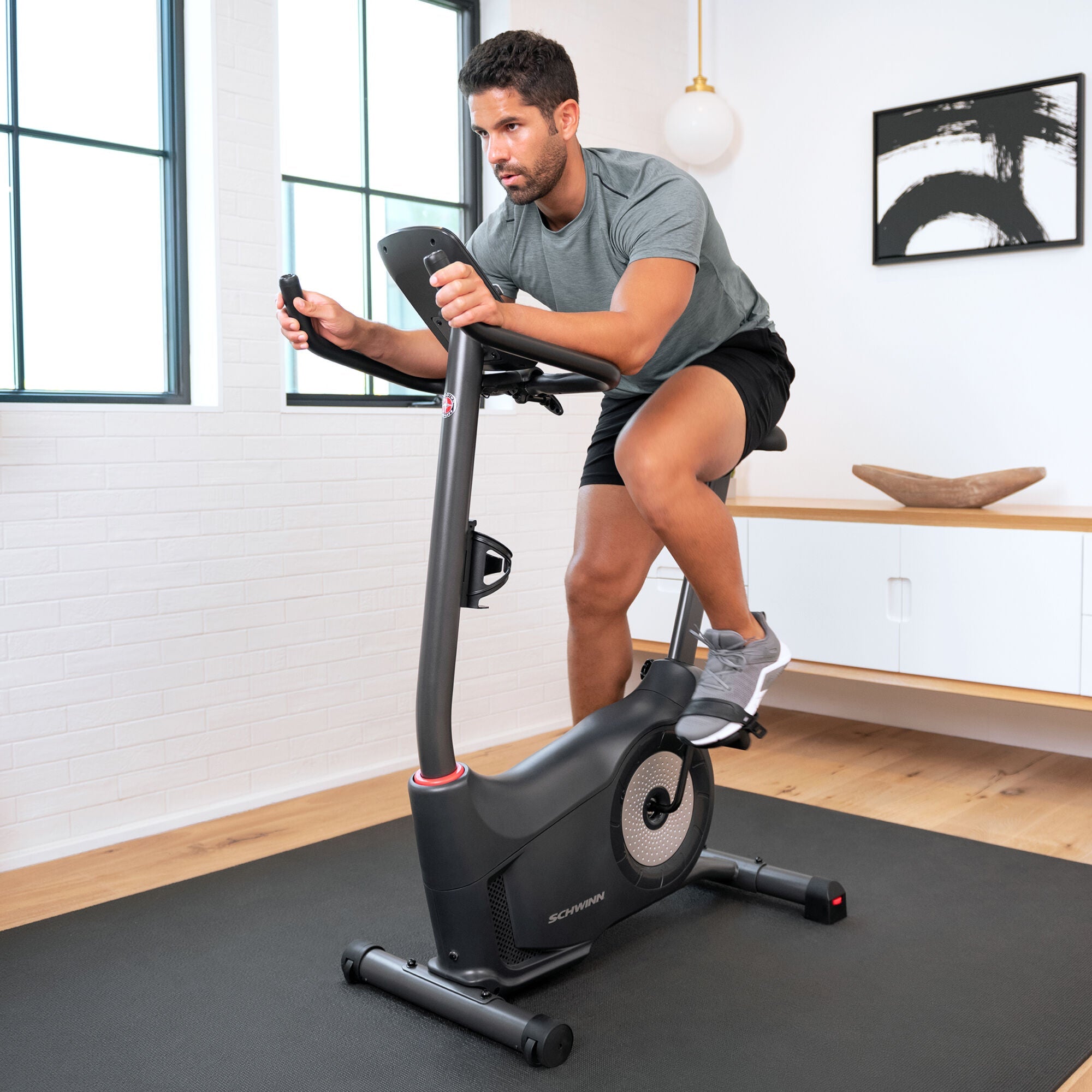 Man using the Schwinn 510U Upright Bike in a home setting.