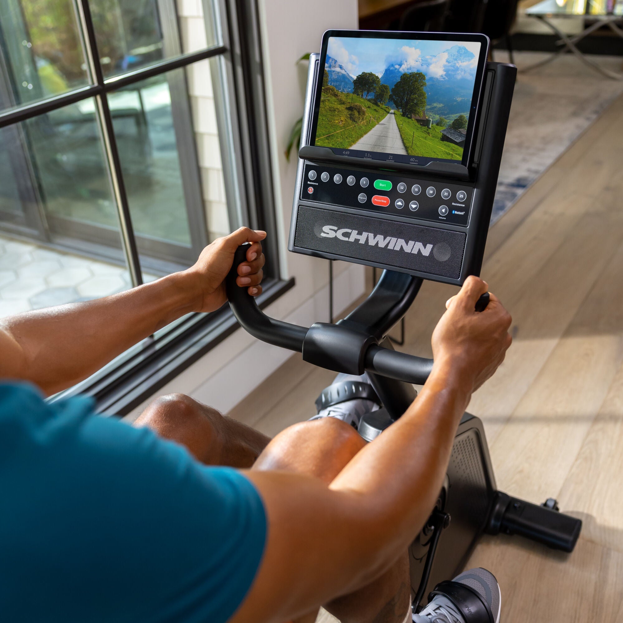 JRNY app screen displayed on tablet resting on the Schwinn 590R Recumbent Bike media shelf.