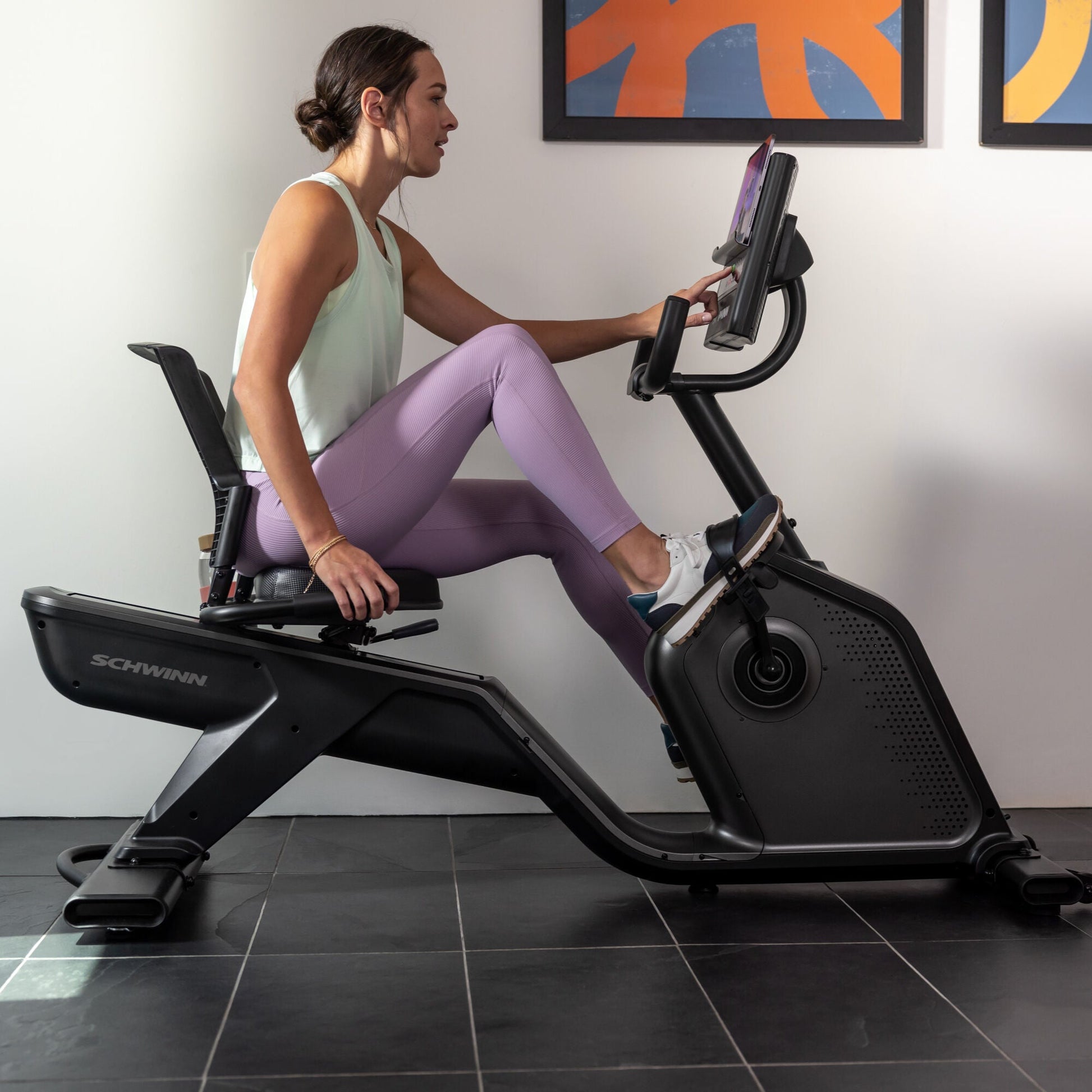 Woman using the Schwinn 590R Recumbent Bike indoors.