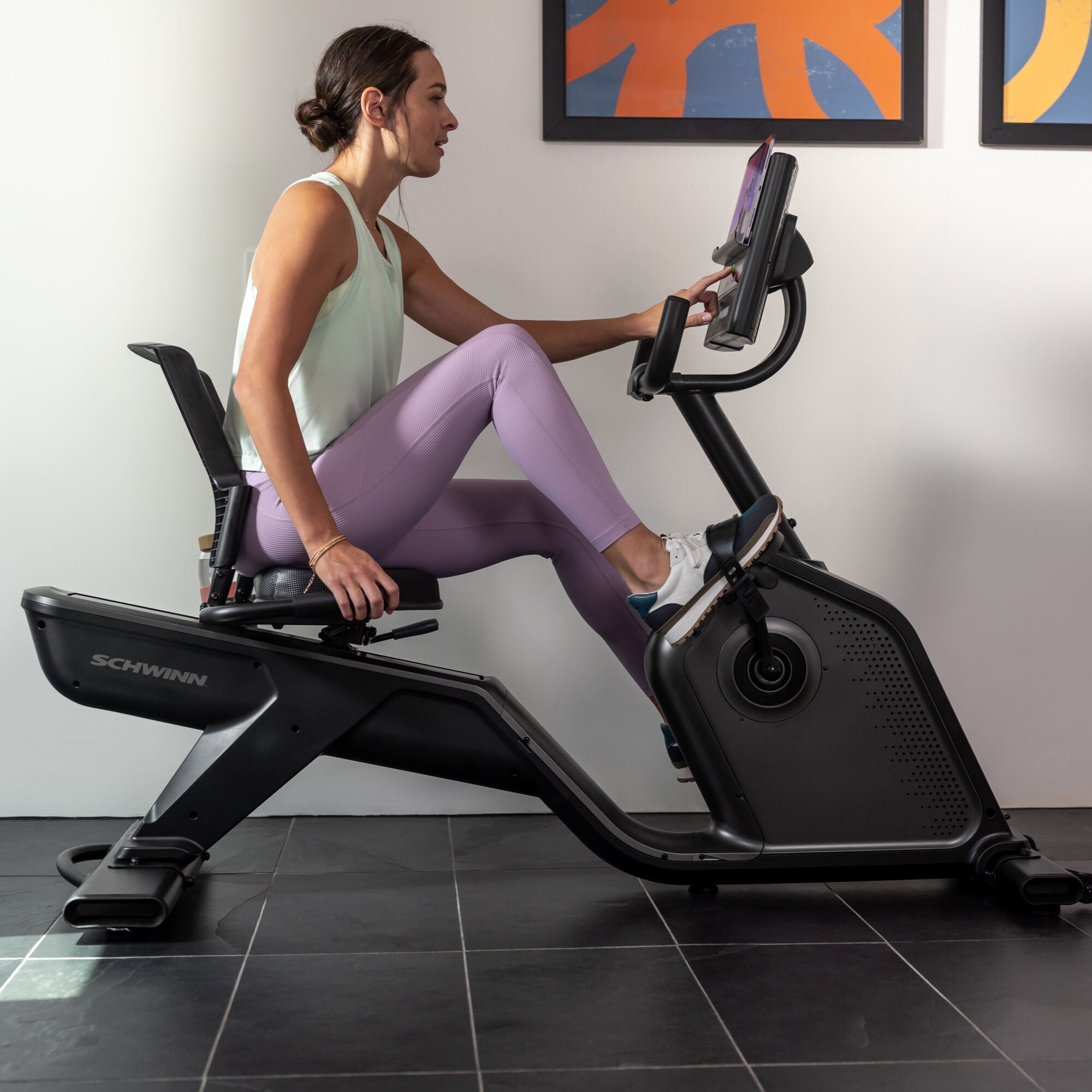Woman using the Schwinn 590R Recumbent Bike indoors.