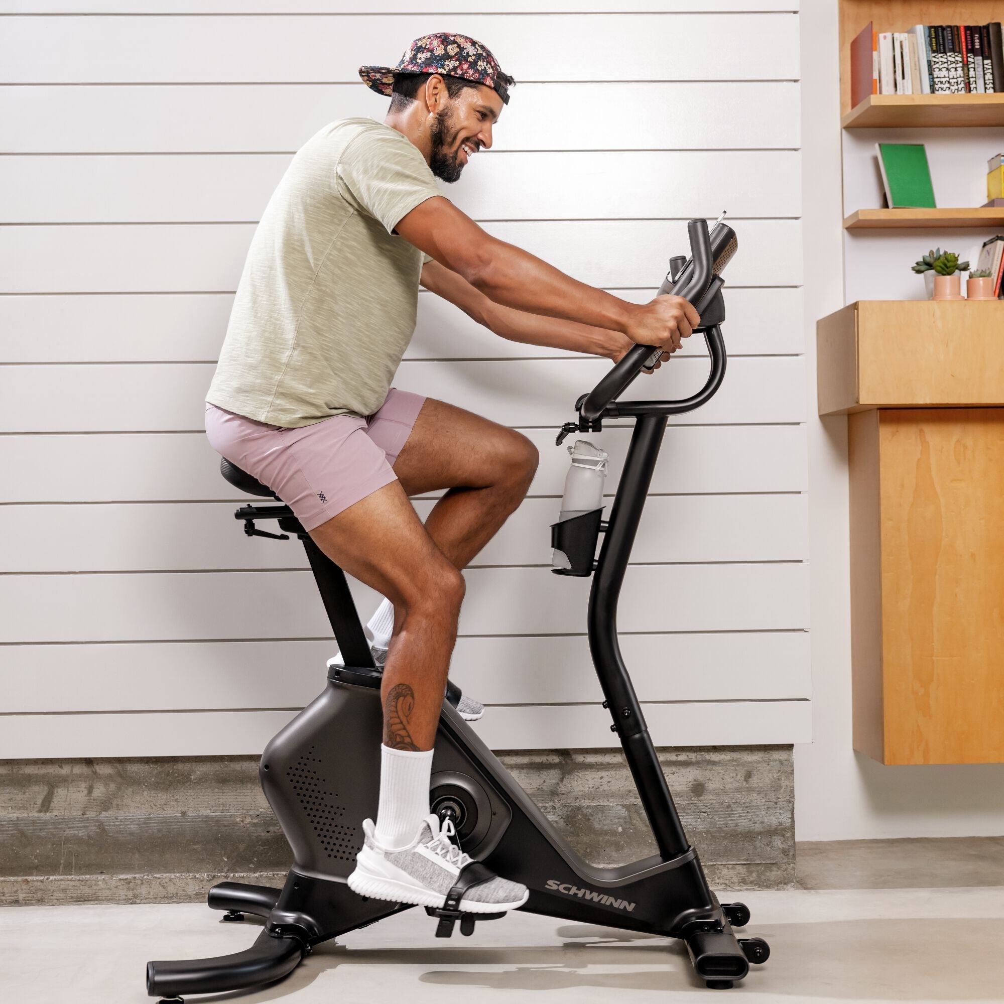 Man using the Schwinn 590U Upright Bike indoors.