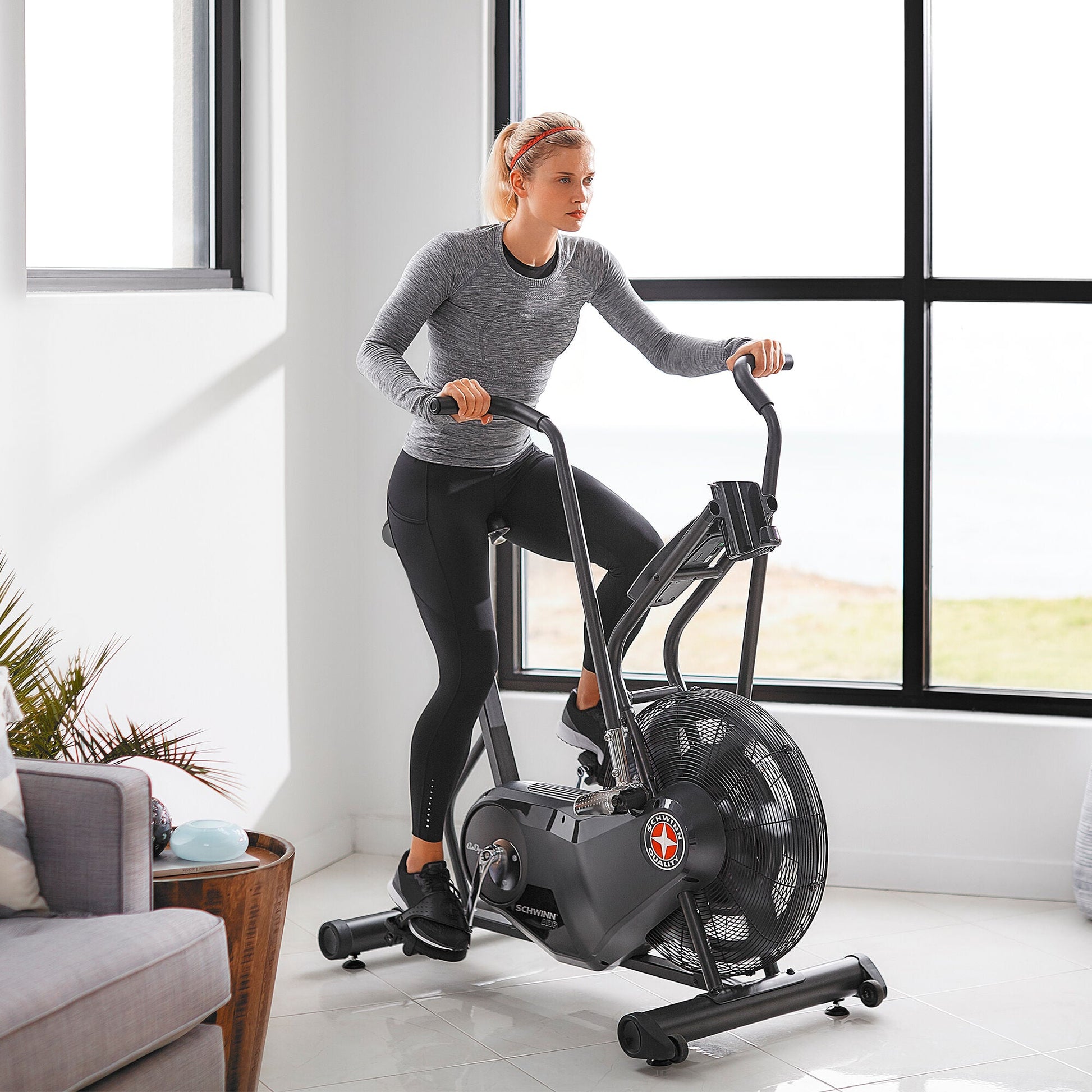 Woman using the Schwinn Airdyne AD6i indoors.