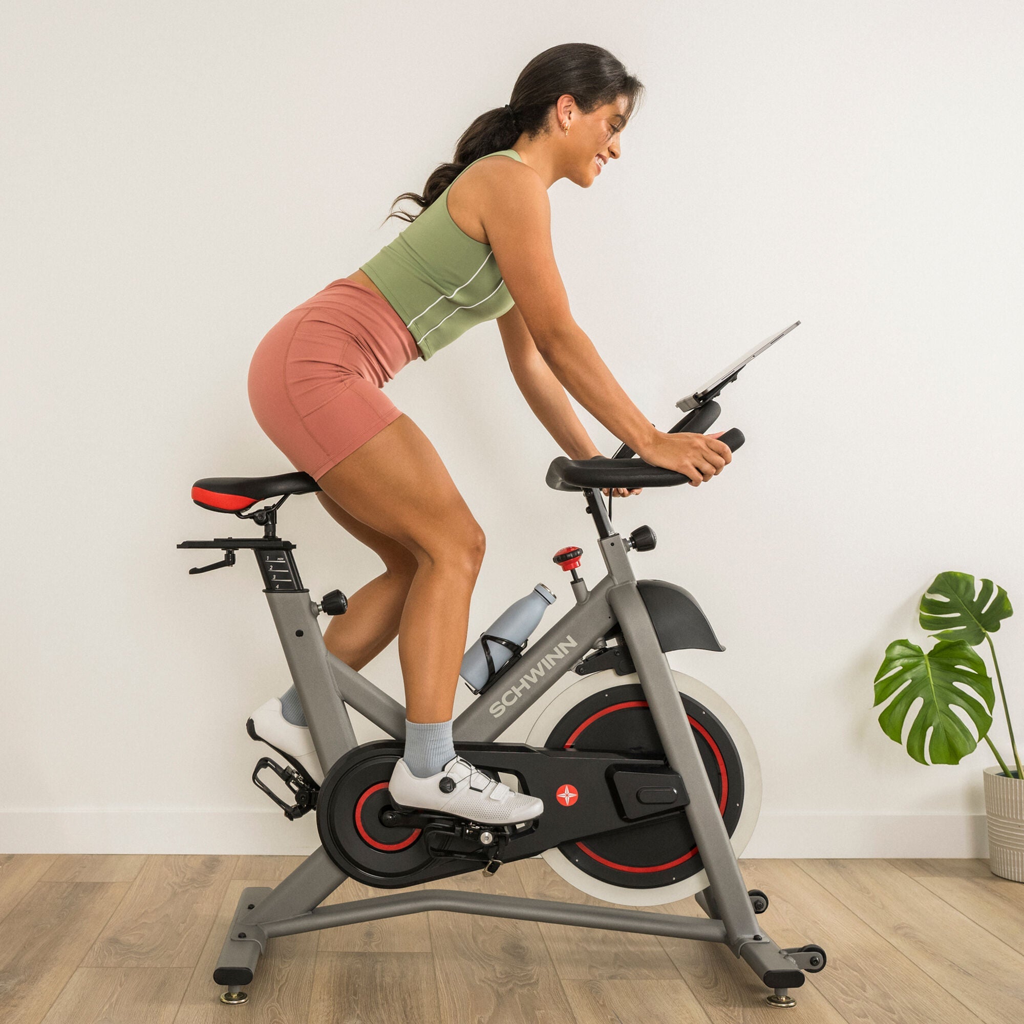 Woman using the Schwinn IC3.5 Indoor Cycling Bike indoors.